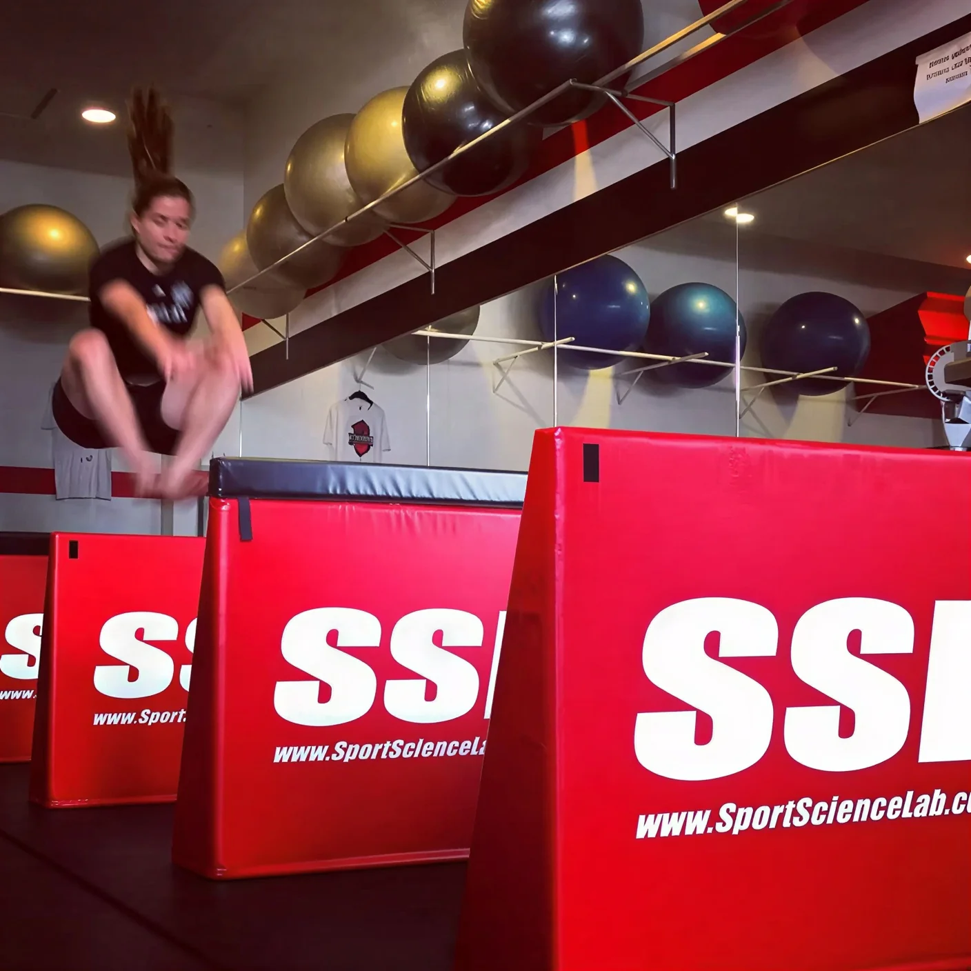 Athlete performing SSL plyometric box jumps