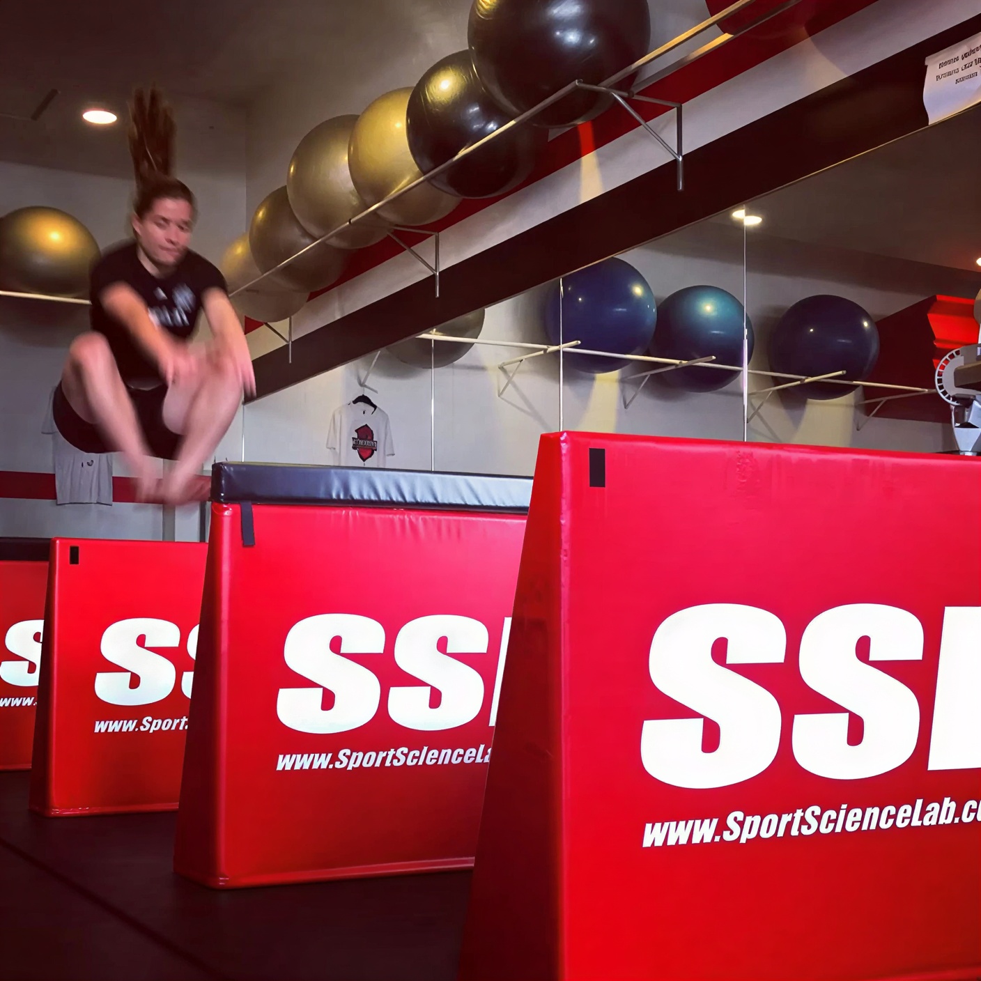 Athlete performing SSL plyometric box jumps